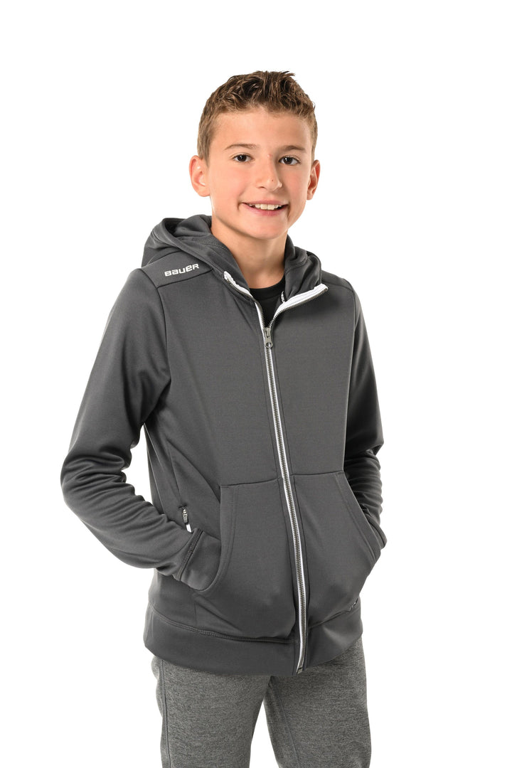 https://www.thehockeyshop.com/cdn/shop/files/bauer-hoodies-s23-bauer-team-fleece-youth-zip-hoody-grey-l-30850492530754_720x.jpg?v=1698424725