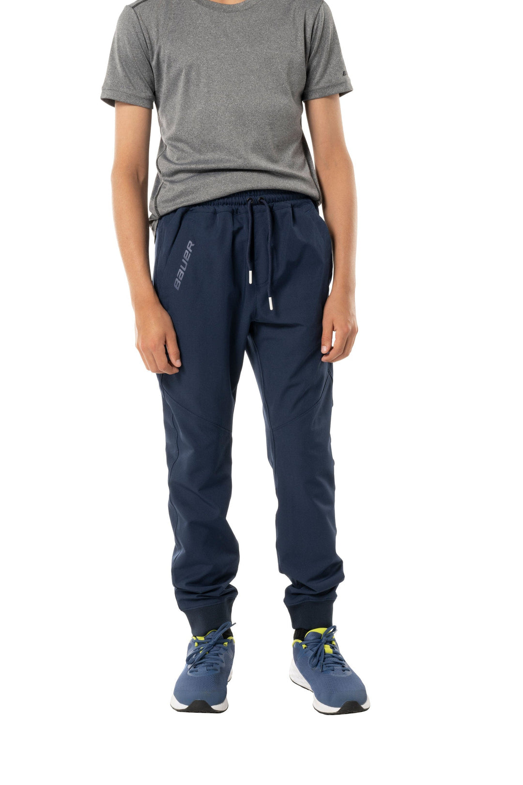 https://www.thehockeyshop.com/cdn/shop/files/bauer-team-pants-s23-bauer-team-woven-youth-joggers-navy-s-30850466447426_1080x.jpg?v=1698423641